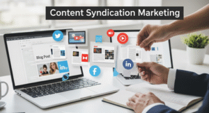 Two laptops display blog posts and social media icons as a person arranges paper cutouts with logos of platforms like Facebook, Twitter, and LinkedIn. The text Content Syndication Marketing appears above, highlighting strategies for boosting reach.